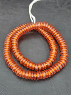 Authentic handmade amber copper Krobo translucent recycled glass rondelle beads from Ghana featuring a matte frosted finish for jewelry making, designer collections, and wholesale sourcing.