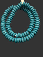 Handcrafted Coastal Lagoon Blue Ashanti glass rondelle beads from Ghana made from recycled glass featuring large holes and a matte artisan finish.
