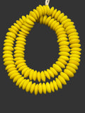Handcrafted Sankofa Gold Ashanti glass rondelle beads from Ghana made from recycled glass featuring large holes and a vibrant matte artisan finish.