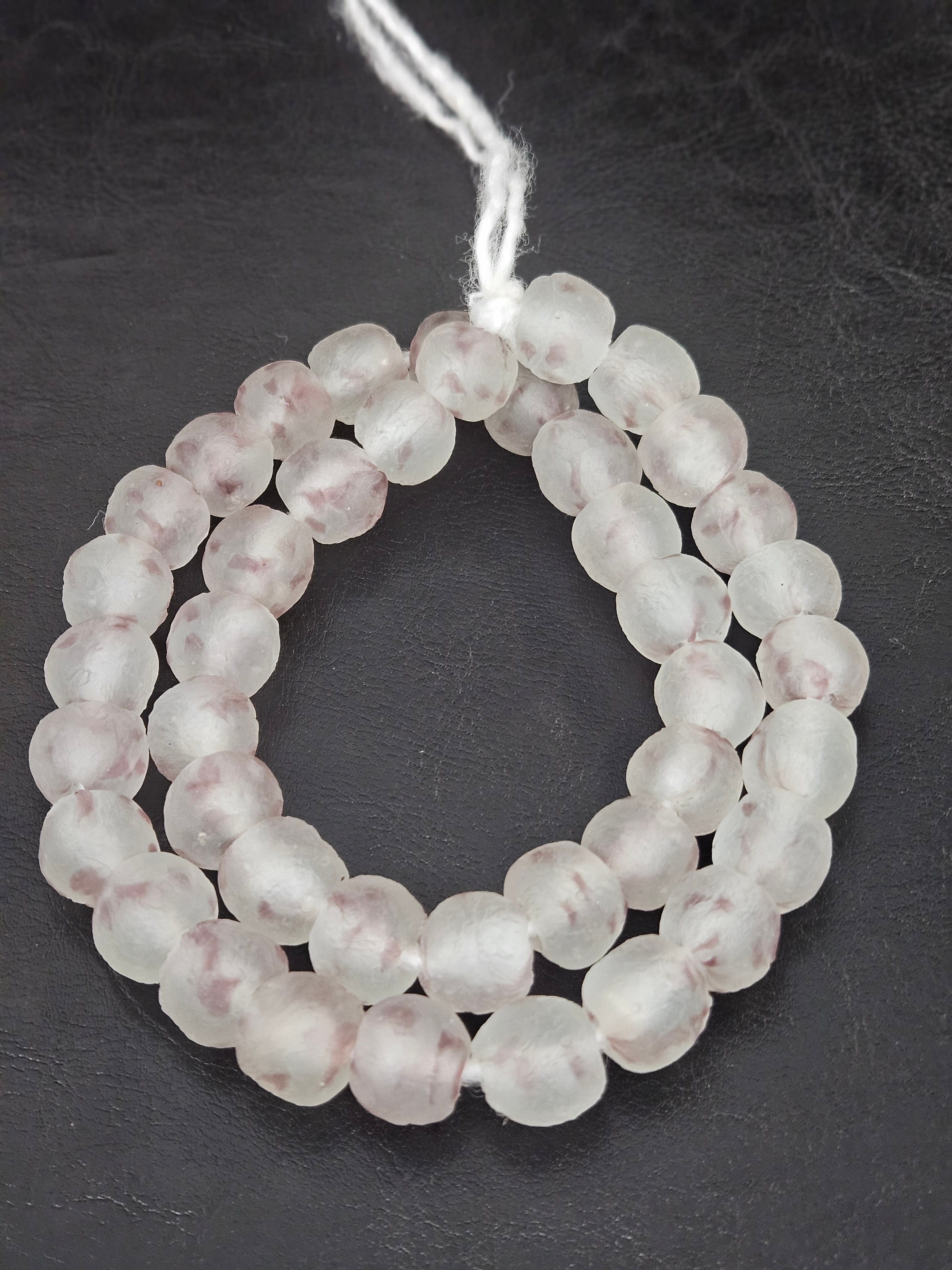 Authentic African beads from Ghana featuring chunky translucent blush frost recycled glass Krobo beads handcrafted by artisans with a matte finish for sustainable jewelry making, luxury design, and cultural collections.