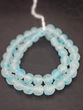 Authentic African beads from Ghana featuring chunky translucent sky blue recycled glass Krobo beads with a frosted matte finish handcrafted by artisans for sustainable jewelry making, designer collections, and cultural materials.