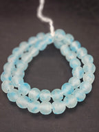 Authentic African beads from Ghana featuring chunky translucent sky blue recycled glass Krobo beads with a frosted matte finish handcrafted by artisans for sustainable jewelry making, designer collections, and cultural materials.