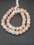 Authentic African beads from Ghana featuring chunky coral speckled translucent recycled glass Krobo beads handcrafted by artisans with a matte frosted finish for sustainable jewelry making and designer collections.