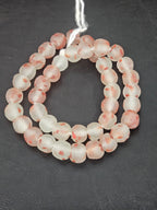 Authentic African beads from Ghana featuring chunky coral speckled translucent recycled glass Krobo beads handcrafted by artisans with a matte frosted finish for sustainable jewelry making and designer collections.