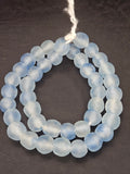 Authentic African beads from Ghana featuring chunky ice blue translucent recycled glass Krobo beads handcrafted by artisans with a matte frosted finish for sustainable jewelry making.