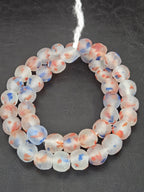 Authentic African translucent red white and blue Krobo recycled glass beads handcrafted in Ghana featuring frosted handmade round beads for luxury jewelry making and designer collections.