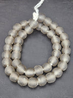 Authentic smoke gray translucent Krobo recycled glass beads handcrafted in Ghana featuring frosted handmade round beads for luxury jewelry making, sustainable designer collections, and contemporary artisan creations