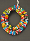 Authentic handcrafted Designer Mix Fused Krobo Rondelle Recycled Glass Beads from Ghana featuring blue, green, yellow, orange, red, black, and white artisan patterns arranged as a full strand for jewelry making and wholesale sourcing.