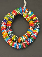 Authentic handcrafted Designer Mix Fused Krobo Rondelle Recycled Glass Beads from Ghana featuring blue, green, yellow, orange, red, black, and white artisan patterns arranged as a full strand for jewelry making and wholesale sourcing.