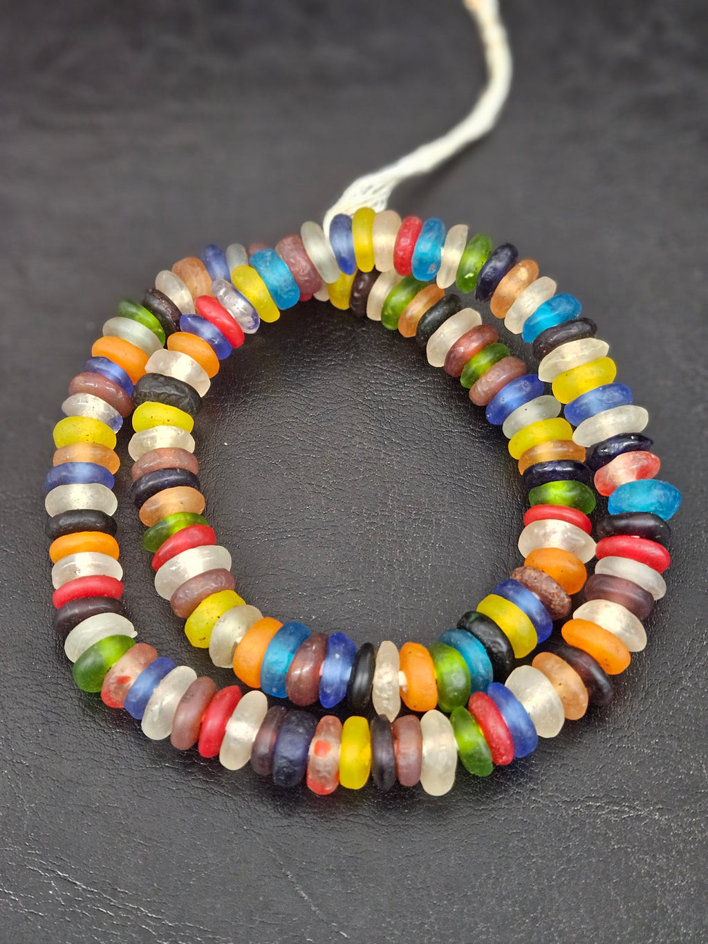 Authentic handmade designer mix Krobo translucent recycled glass rondelle beads from Ghana featuring vibrant multicolor frosted finishes for jewelry making and wholesale sourcing.