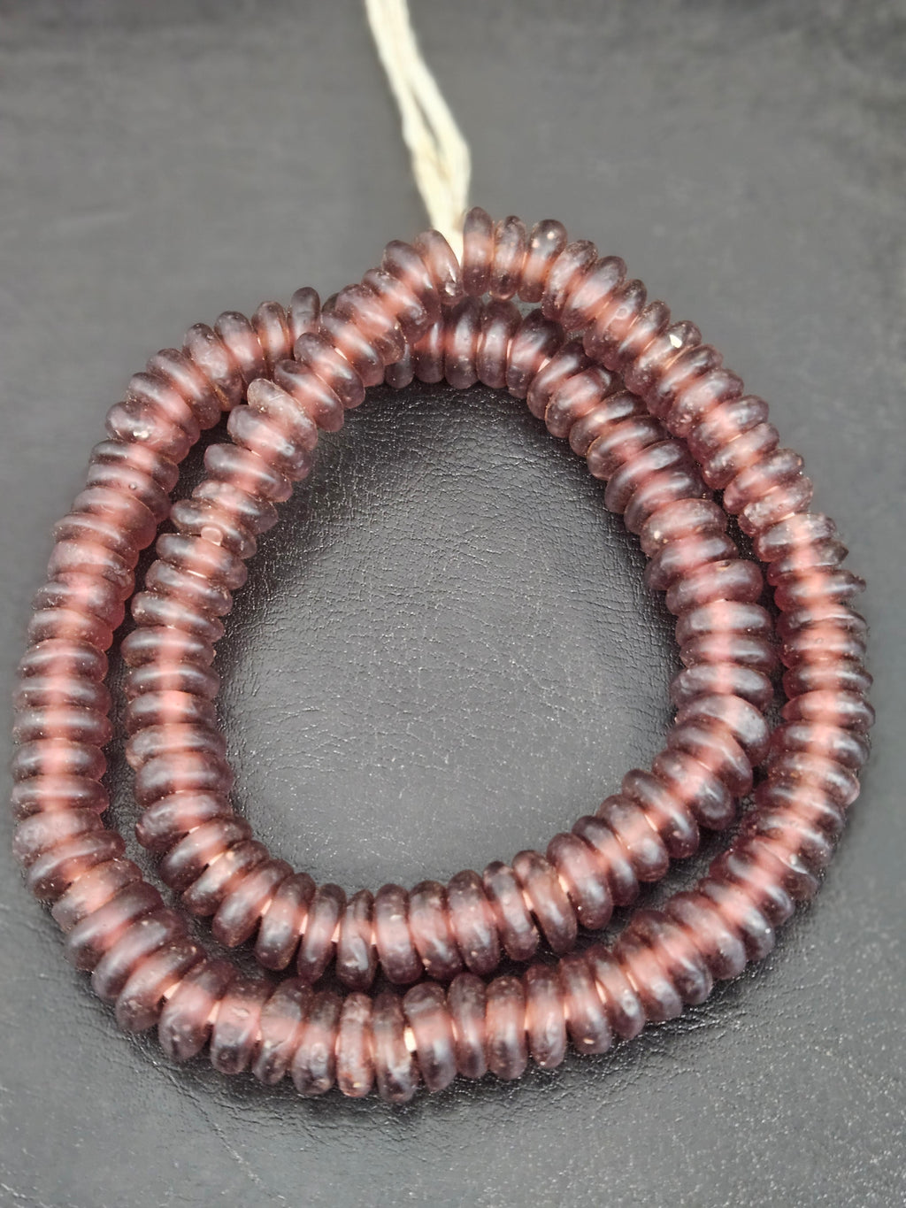 Authentic handmade dusty plum Krobo translucent recycled glass rondelle beads from Ghana with a matte frosted finish arranged as a full strand for jewelry making, designer collections, and wholesale sourcing.

26. PRO-TIPS
