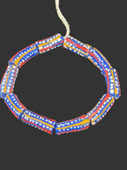 Handcrafted red white and blue painted Krobo glass beads from Ghana featuring white dotted patterns and gold accents on large recycled glass tube beads.