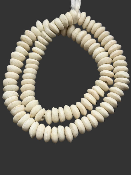 Ivory White Ashanti Glass Rondelle Beads handcrafted in Ghana from recycled glass featuring large holes, matte artisan finish, and neutral ivory color for jewelry making and designer collections.