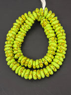 Authentic handcrafted lime green Fused Krobo Rondelle Recycled Glass Beads from Ghana featuring golden artisan patterns and matte recycled glass finish, displayed as a full designer strand for jewelry making and wholesale sourcing.