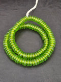 Authentic handmade lime green Krobo translucent recycled glass rondelle beads from Ghana featuring a frosted matte finish for jewelry making and wholesale sourcing.