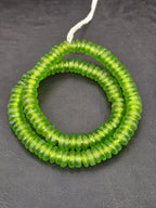 Authentic handmade lime green Krobo translucent recycled glass rondelle beads from Ghana featuring a frosted matte finish for jewelry making and wholesale sourcing.