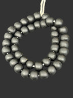 Handcrafted Midnight Eclipse Krobo Pocket Glass Beads from Ghana featuring matte black recycled glass with authentic artisan craftsmanship.