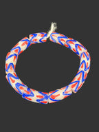 Handcrafted red white and blue painted Krobo glass beads from Ghana featuring large-hole tube beads made from recycled glass for statement jewelry and heritage-inspired designs.