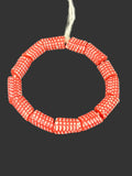 Handcrafted red and white painted Krobo glass beads from Ghana featuring detailed white polka dot patterns on large-hole recycled glass tube beads.