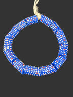 Handcrafted royal blue painted Krobo glass beads from Ghana featuring white dot patterns and red accents on large-hole recycled glass tube beads.