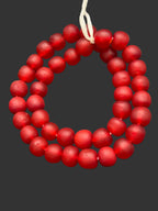Handcrafted Ruby Frost Krobo Pocket Glass Beads from Ghana featuring frosted translucent red recycled glass with artisan craftsmanship.