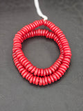 Authentic handmade ruby red Krobo translucent recycled glass rondelle beads from Ghana featuring a matte frosted finish for jewelry making and wholesale sourcing.