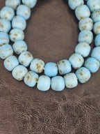 Authentic handcrafted sky blue Krobo powdered glass beads from Ghana featuring organic round recycled glass beads with matte finish and natural earth-toned artisan speckles.