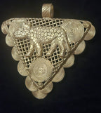 Oversized African brass tiger pendant from Ghana with Adinkrahene-inspired concentric circular motifs.