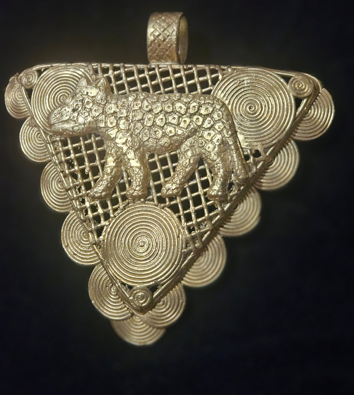 Oversized African brass tiger pendant from Ghana with Adinkrahene-inspired concentric circular motifs.