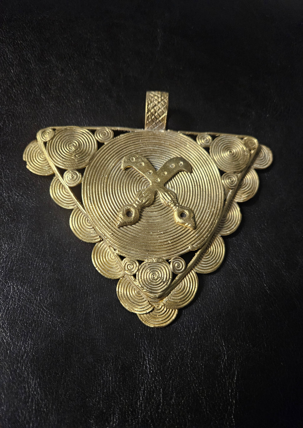 Oversized Akofena Adinkra brass pendant from Ghana with crossed swords on a concentric circular center.