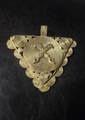 Oversized Akofena Adinkra brass pendant from Ghana with crossed swords on a concentric circular center.