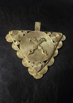 Oversized Akofena Adinkra brass pendant from Ghana with crossed swords on a concentric circular center.