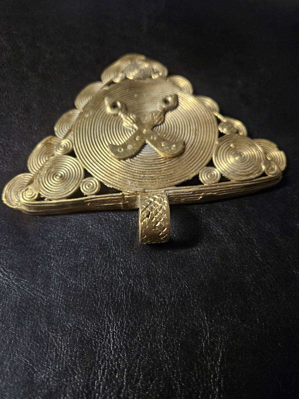 Oversized African brass Akofena pendant shown for scale with geometric frame and adinkrahene decoration.
