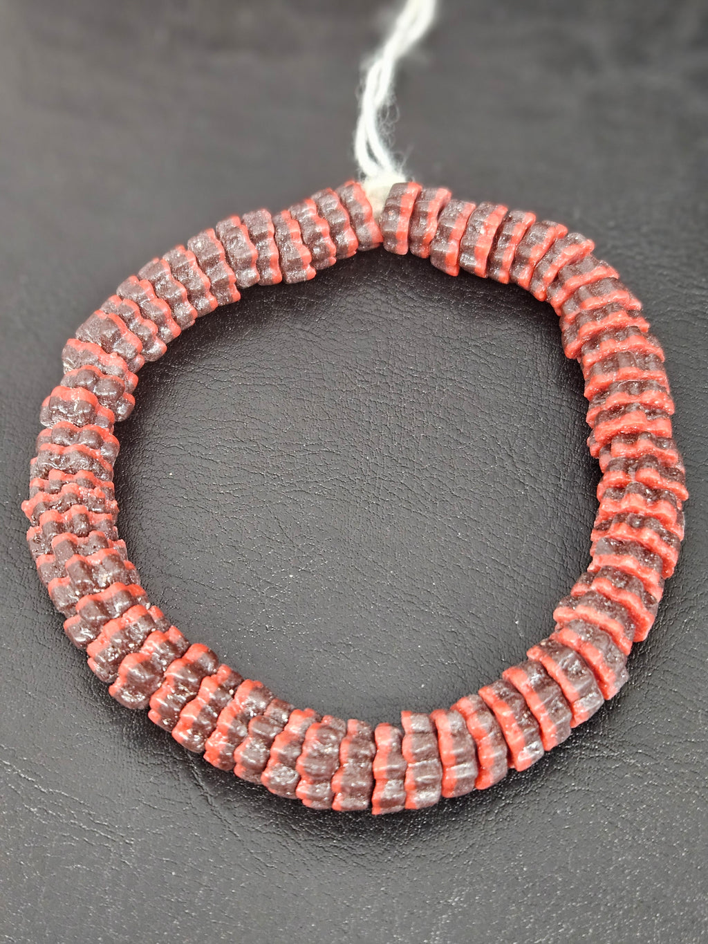 Handcrafted brown and coral red Krobo glass spacer beads from Ghana featuring recycled glass artisan craftsmanship and striped spacer-bead design.
