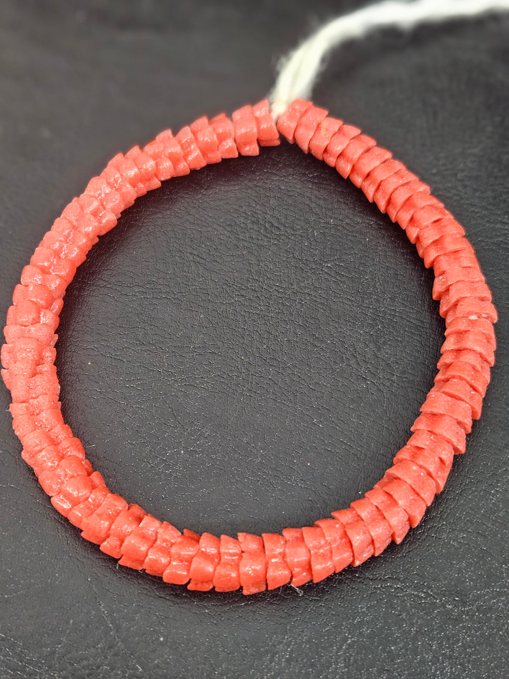Handcrafted coral Krobo glass spacer beads from Ghana featuring recycled glass artisan craftsmanship and traditional handmade beadmaking techniques.