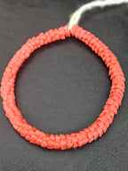 Handcrafted coral Krobo glass spacer beads from Ghana featuring recycled glass artisan craftsmanship and traditional handmade beadmaking techniques.