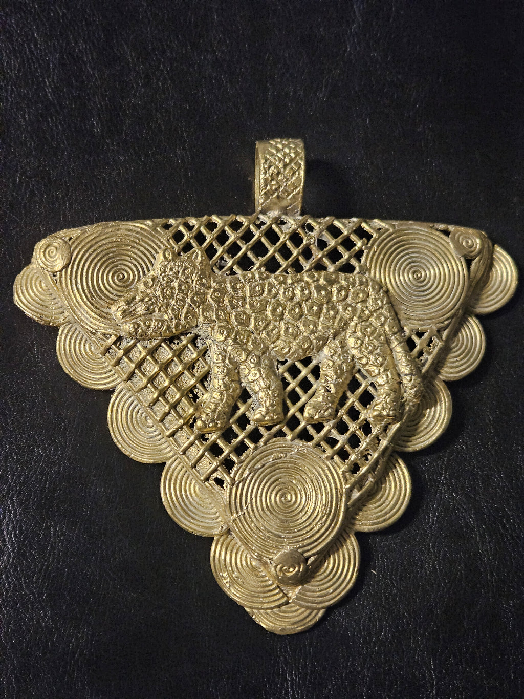 lose view of dimensional tiger on handcrafted Ghanaian brass statement pendant.