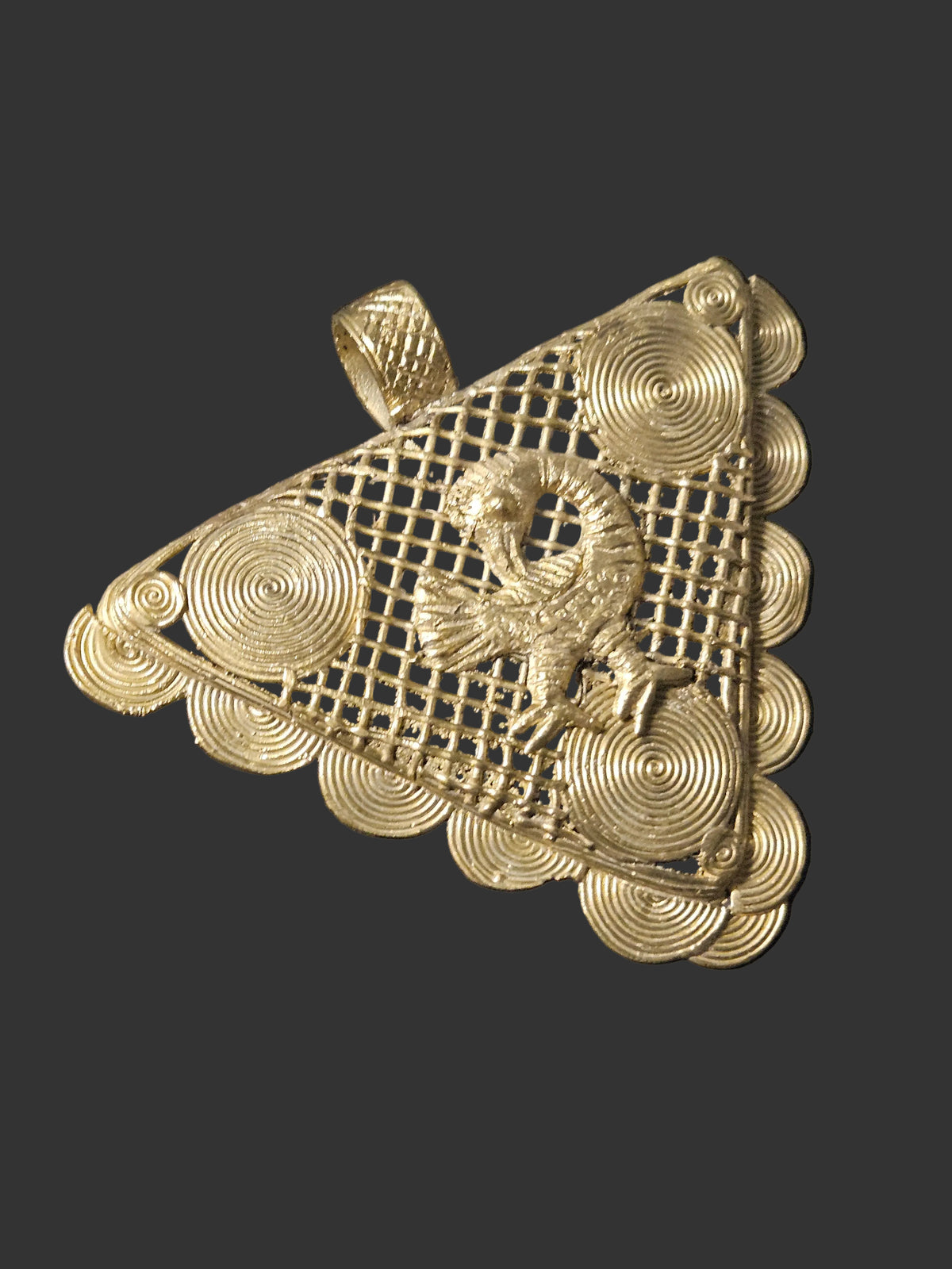 Oversized Sankofa brass pendant shown beside a scale reference to demonstrate its substantial size.
Use only if the photograph contains an actual scale reference