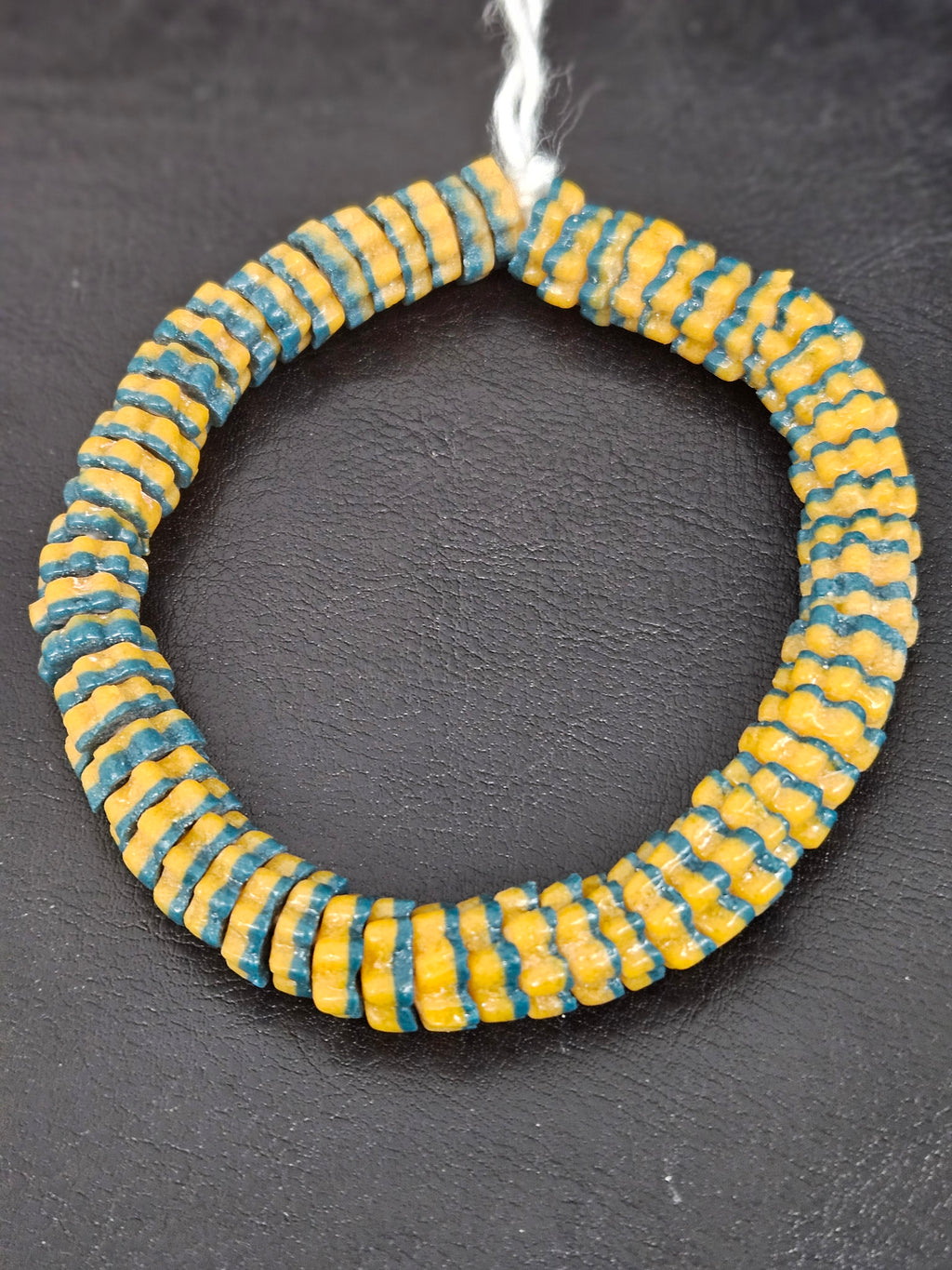 Handcrafted golden yellow and teal blue Krobo glass spacer beads from Ghana featuring recycled glass artisan craftsmanship and striped spacer-bead design.