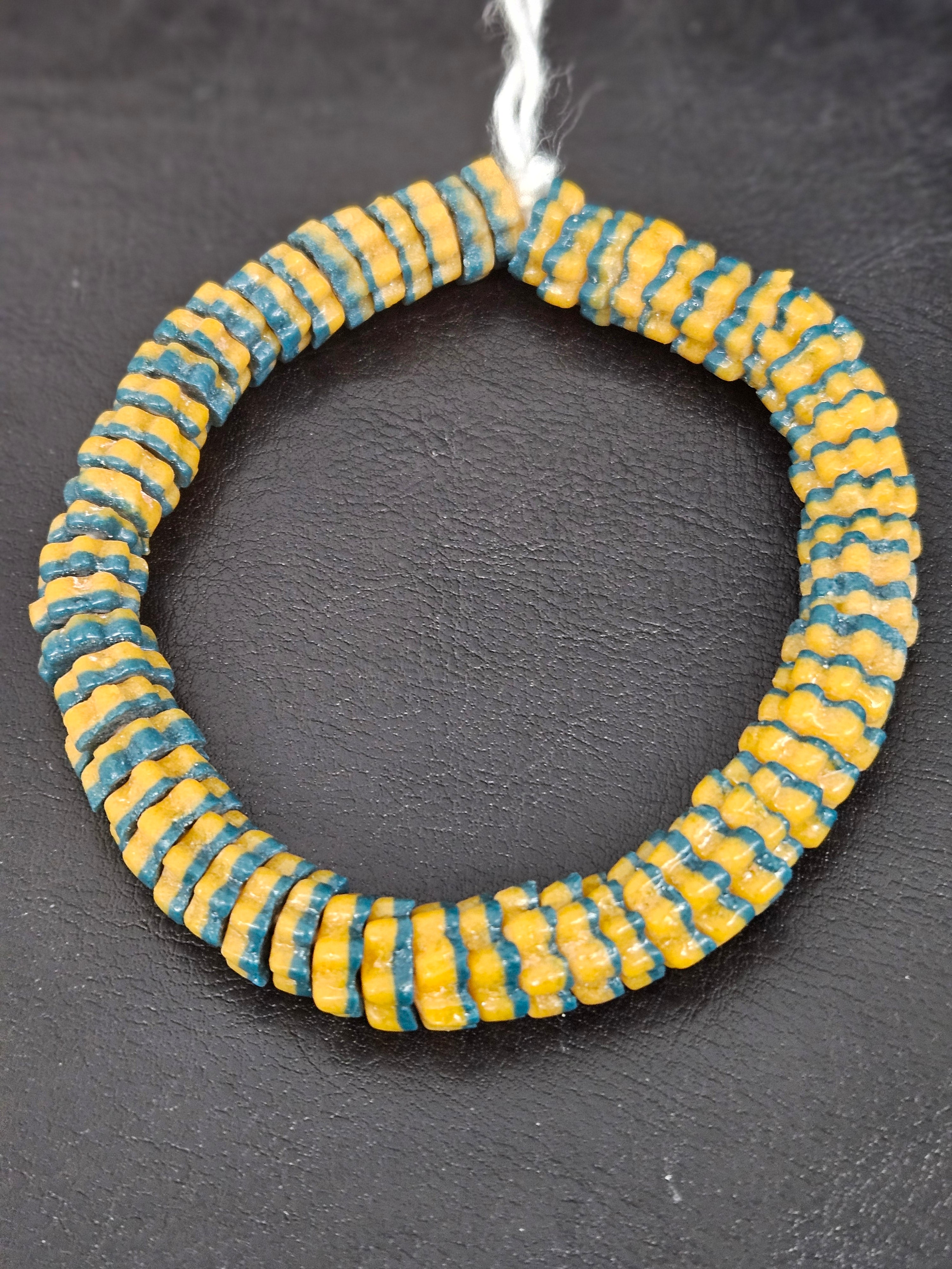Handcrafted golden yellow and teal blue Krobo glass spacer beads from Ghana featuring recycled glass artisan craftsmanship and striped spacer-bead design.