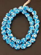 Authentic Fused Krobo recycled glass beads handcrafted in Ghana featuring aqua blue and ivory marbled patterns on approximately 44 artisan-made beads strung on a strand.