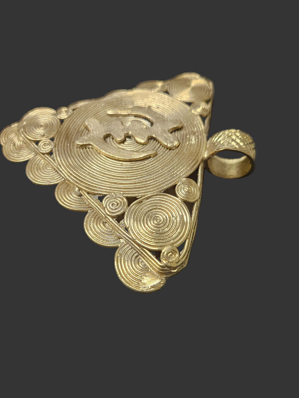 Side view of oversized Ghanaian Adinkra brass pendant showing its dimensional profile and handcrafted construction.