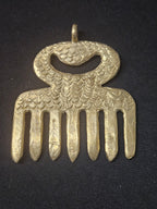 Oversized handcrafted Duafe Adinkra symbol pendant made from traditional Ashanti brass in Ghana representing beauty, dignity, self-care, personal excellence, and cultural heritage.