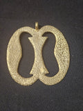 Oversized handcrafted Nkonsonkonson Adinkra symbol pendant made from traditional Ashanti brass in Ghana representing unity, interconnectedness, cooperation, and human relationships.