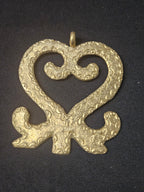 Oversized handcrafted Sankofa Adinkra symbol pendant made from traditional Ashanti brass in Ghana representing learning from the past, cultural heritage, wisdom, and continuity.