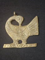 Oversized handcrafted Sankofa Bird Adinkra symbol pendant made from traditional Ashanti brass in Ghana representing wisdom, heritage, learning from the past, and cultural continuity.