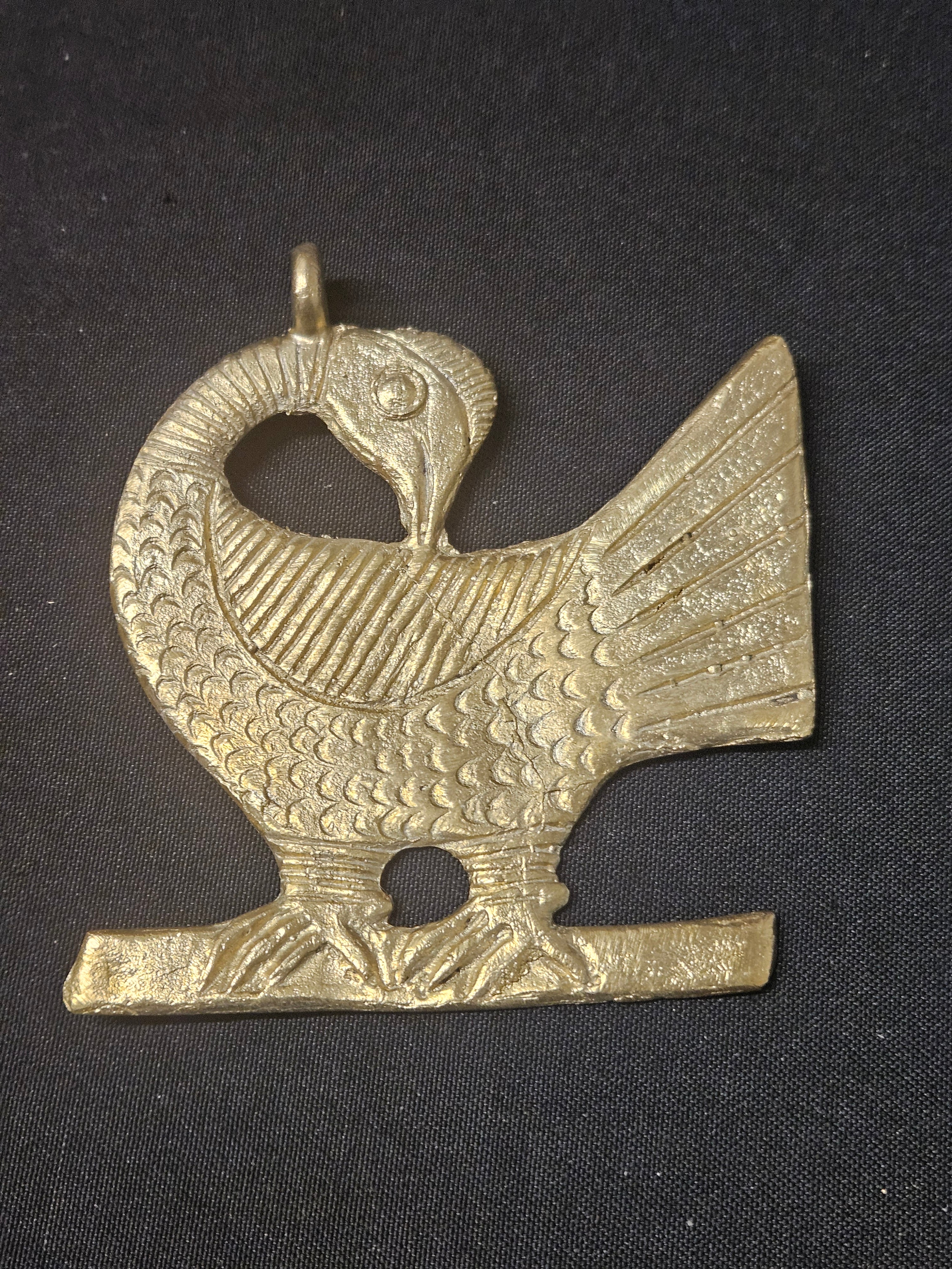 Oversized handcrafted Sankofa Bird Adinkra symbol pendant made from traditional Ashanti brass in Ghana representing wisdom, heritage, learning from the past, and cultural continuity.