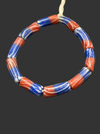 Handcrafted red white and blue painted Krobo glass tube beads from Ghana made from recycled glass for jewelry making and heritage-inspired designs.