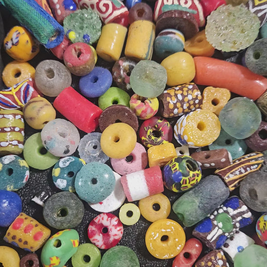 Video of close-up bright Krobo beads highlighting painted details.