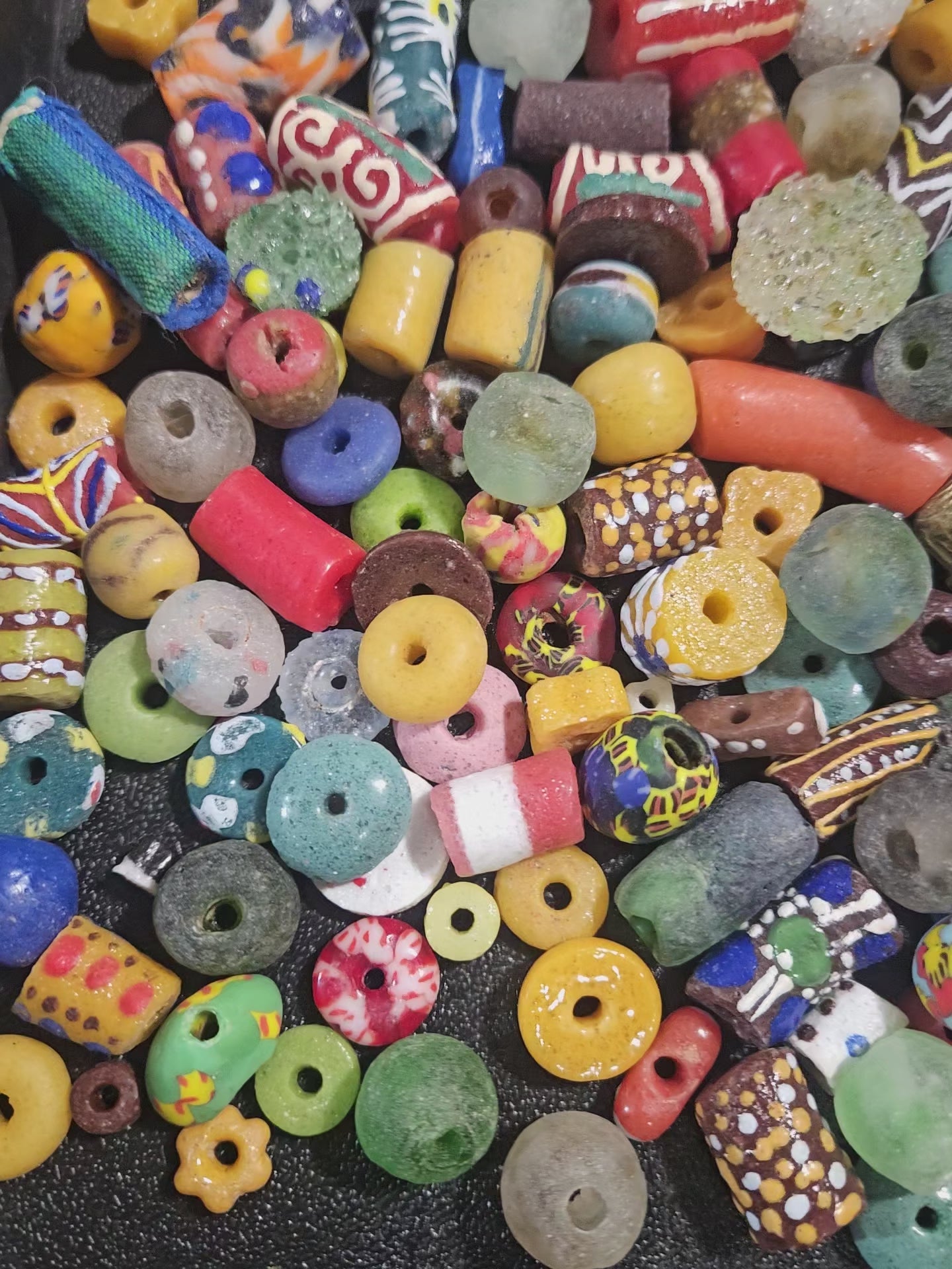 Video of close-up bright Krobo beads highlighting painted details.